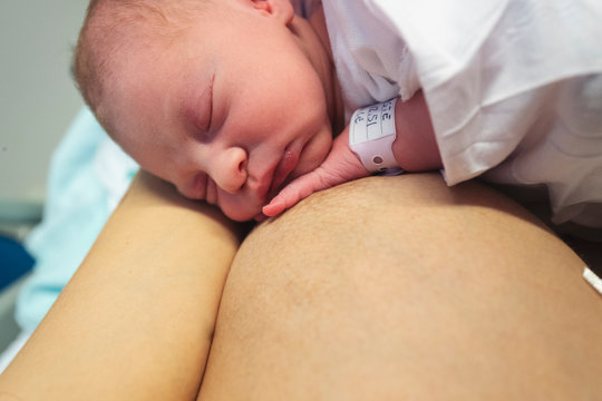 Newborn sleeping on mother's breast