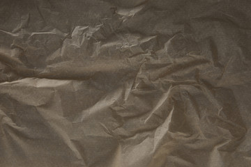 top view of dark beige wrinkled parchment paper surface with copy space