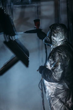 Worker painter at industrial factory