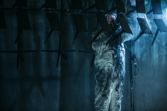 Worker painter at industrial factory