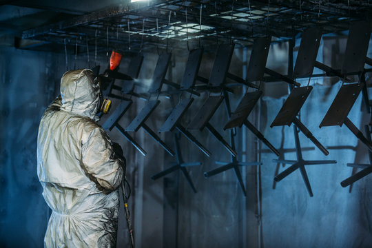 Worker painter at industrial factory