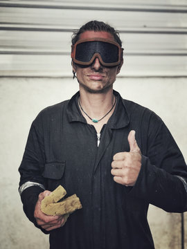 portrait of a dirty and wet guy with skiing goggles