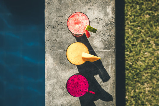 fresh colorful fruit juices in a row from above