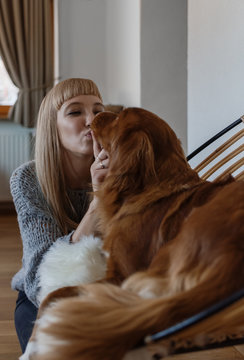 Woman caressing beautiful purebred dog