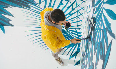 Street Artist Working On Mural.