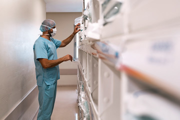 Unrecognizable doctor working with boxes