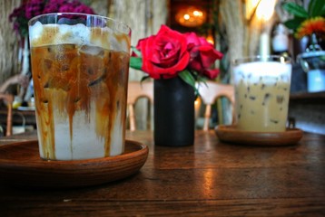 Iced coffee on a wooden table in a vintage style cafe