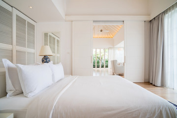 Interior of spacious white bedroom decorated