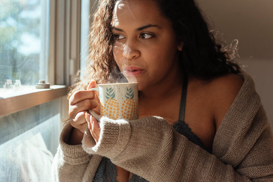 Portraits of a beautiful pluz sized woman in her bra and underwear at home