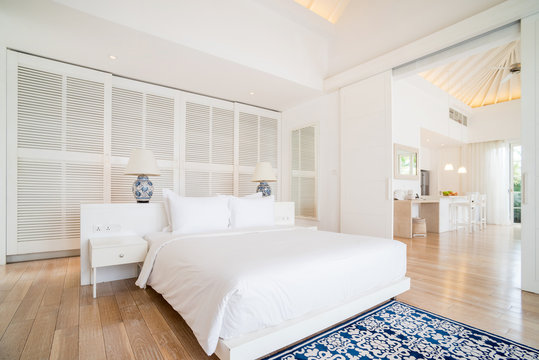 Interior of spacious white bedroom decorated