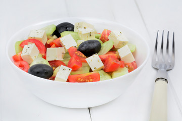 Vegetables with cheese in a bowl on table