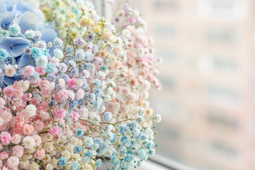 a nice colourful bunch of small flowers by a window
