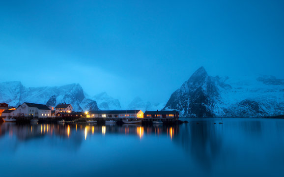 Winter panorama of mount Olstind above the red fishing cabins called Rorbu in town of Hamnoy on Lofoten islands, Norway