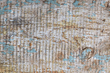 Old gray-brown natural wood background in the form of a board with cracks, knots and a rough surface
