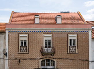 Decorative ceramic tiles on a large house with balconies in Alfama district of Lisbon, Portugal