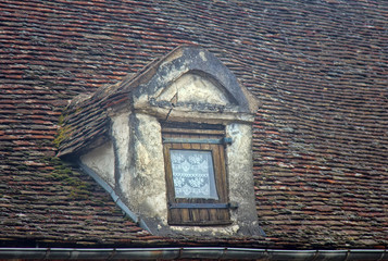 The Dormer window and the tiled roof of the old house