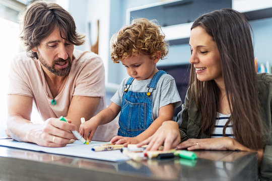 Adorable happy family drawing at home
