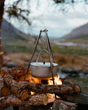 bowler on the fire in Ctoru cooks food. nature and holidays in the mountains
