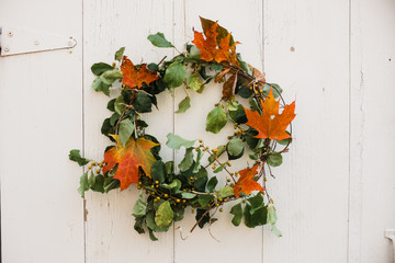 fall wreath on a white barn door
