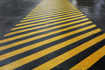 Yellow-black signal strip at the factory. Floor painting for worker safety. Allocation of hazardous...