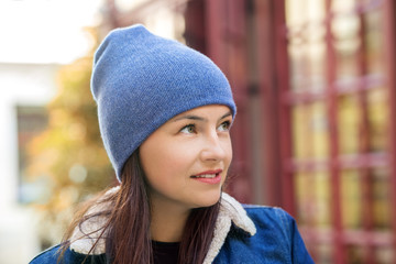 Walk around the city in cold weather. Woman in a blue hat. Concept lifestyle, autumn