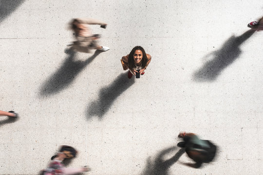 Portrait of happy young woman looking up, top view