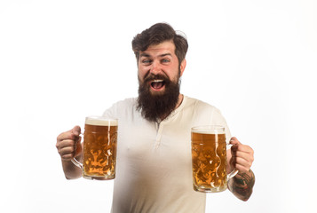 Beer pub. Smiling bearded hipster drinking craft beer from mug. Alcohol, harmful habits. Oktoberfest. Stylish handsome man drinking beer of glass on party. Brewing. Stylish guy at cafe pub. Beer time.