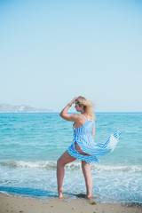 Naklejka premium Plus size woman in holidays, Picturesque view of the beach. Vacations and adventure concept 