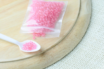 Colorful beads on a wooden surface. Various of shapes and colors to make jewelry