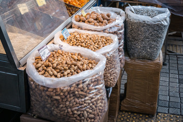 Raw peanuts, pistachios, walnuts and sunflower seeds in the large transparent plastic bags on the Central Market of Athens.