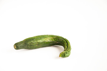 dried not fresh green cucumber lies on a table on a white background