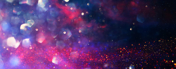 background of abstract red, gold and purple glitter lights. defocused. banner