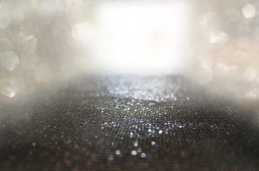 glitter vintage lights background. black and silver. de-focused