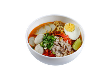 Spicy tom yam pork noodle soup with lemongrass, chili paste, boiled egg and lime juice isolated on white background