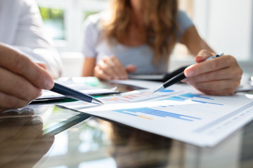 Two Businesspeople Analyzing Graph