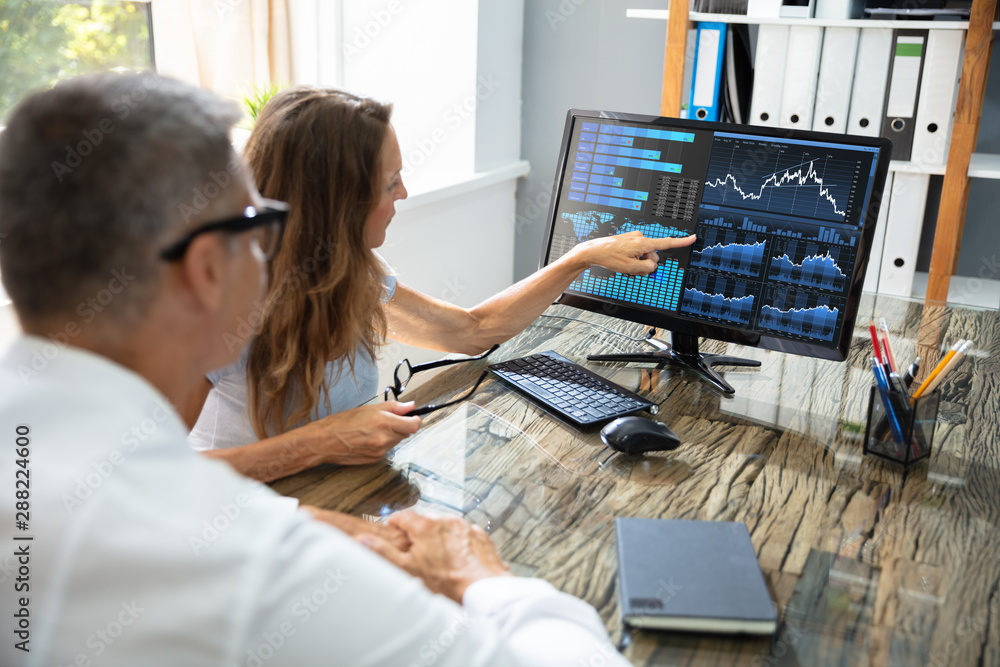 Poster two stock market brokers discussing graphs on computer