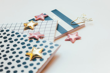 Desktop feminine composition. Notepads and stars