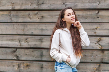 Happy girl smiling. Beauty portrait young happy positive laughing brunette woman on wooden wall...