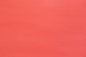 Background in the form of a wooden surface painted in coral color with textured stripes.