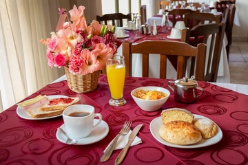 Classic breakfast based on coffee, bread, cold meats, orange juice, cake portion, cereals and meatloaf