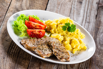 Grilled pork chops with mashed potatoes and vegetables