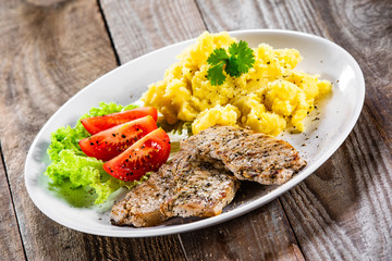 Grilled pork chops with mashed potatoes and vegetables