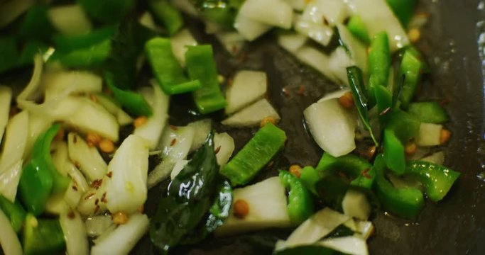 Slow motion shot of cooking a simple and easy vegetarian curry.