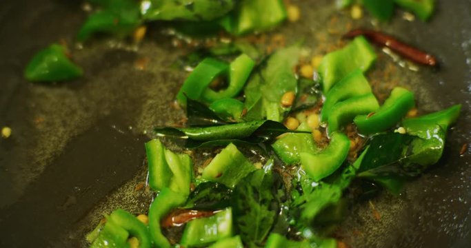 Slow motion shot of cooking a simple and easy vegetarian curry.