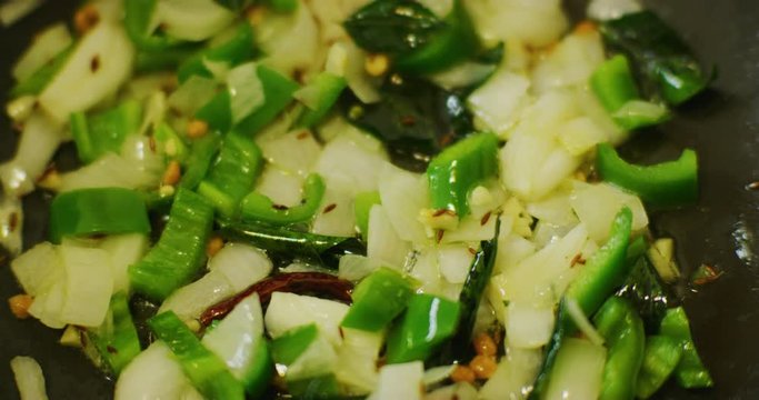 Slow motion shot of cooking a simple and easy vegetarian curry.