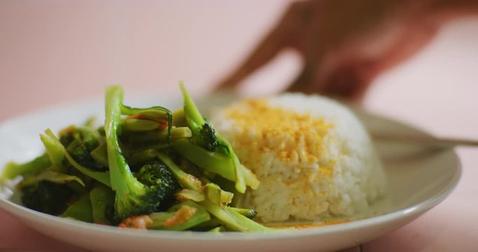 Slow motion shot of cooking and plating a simple and easy vegetarian curry.
