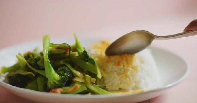 Slow motion shot of cooking and plating a simple and easy vegetarian curry.