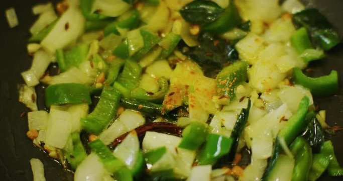 Slow motion shot of cooking a simple and easy vegetarian curry.