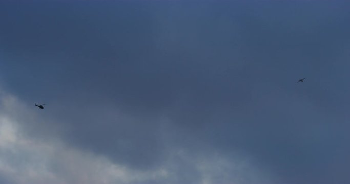Slow motion of News Helicopters waiting for thunderbirds to fly over Hollywood. Los Angeles, California