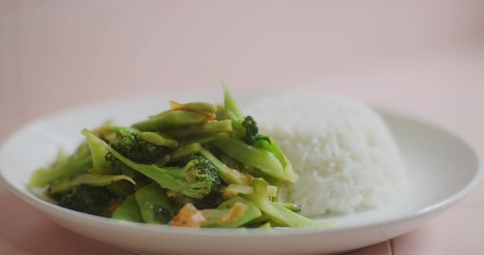 Slow motion shot of cooking and plating a simple and easy vegetarian curry.